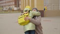 a happy mother meets a child with a school backpack from school, a little kid comes back to his mother after school