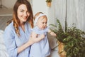 Happy mother and 9 month old baby in matching pajamas playing in bedroom in the morning Royalty Free Stock Photo