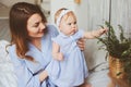 Happy mother and 9 month old baby in matching pajamas playing in bedroom in the morning Royalty Free Stock Photo