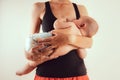 Happy mother with newborn baby infant on hands standing and breasfeeding lacting lactation health and care bonding time