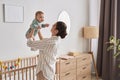 Happy Mother Playing with Baby Boy at Home And Enjoying Motherhood Royalty Free Stock Photo