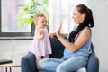 Happy mother playing with baby daughter at home Royalty Free Stock Photo