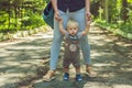 Happy mother playing with baby in the park in autumn. Kid smiling at mum on hands at the park in autumn Royalty Free Stock Photo