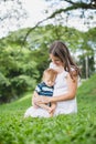 Happy mother playing with her son in the park