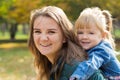 Happy mom with a smile playing with her daughter in the park on a summer day Royalty Free Stock Photo