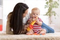 Happy mother playing with baby at home Royalty Free Stock Photo