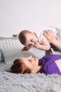 Happy mother plays with her little baby on bed Royalty Free Stock Photo