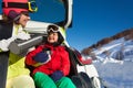Happy mother pouring tea for her son after skiing Royalty Free Stock Photo