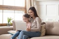 Happy mother and preschool daughter using laptop together at home Royalty Free Stock Photo