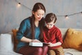 happy mother reading book to child son at home,