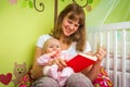 Happy mother reading a book to her baby girl Royalty Free Stock Photo