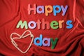 Happy Mother`s Day alphabet blocks arranged on red background. Mother`s day gift box. Happy Mother`s day concept. Royalty Free Stock Photo