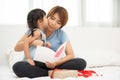 Asian little girl kissing her mother. Royalty Free Stock Photo