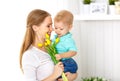 Happy mother`s day. Baby son gives flowers for mom Royalty Free Stock Photo