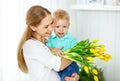 Happy mother`s day. Baby son gives flowers for mom Royalty Free Stock Photo