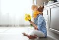 Happy mother`s day! baby son gives flowersfor mother on holiday