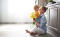 Happy mother`s day! baby son gives flowersfor mother on holiday