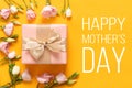 Happy Mother`s Day Background. Bright Yellow and Pastel Pink Colored Mother Day Background. Flat lay greeting card with gift box.