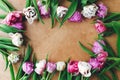 Happy mother`s day. Beautiful double peony tulips frame flat lay on wooden table, space for text. Colorful pink and purple tulips Royalty Free Stock Photo