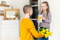 Happy Mother`s Day or Birthday Background. Adorable young girl surprising her mom with homemade greeting card. Family celebration.