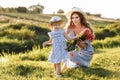 Happy mother`s day. Child daughter congratulates mom and gives her a bouquet of flowers outdoors. Mum and girl smiling and huggin Royalty Free Stock Photo