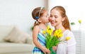 Happy mother`s day! Child daughter congratulates moms and gives Royalty Free Stock Photo