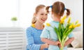 Happy mother`s day! Child daughter congratulates moms and gives Royalty Free Stock Photo