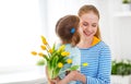 Happy mother`s day! Child daughter congratulates moms and gives Royalty Free Stock Photo