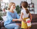 Happy mother`s day! Child daughter congratulates moms and gives her a postcard and yellow flowers tulip Royalty Free Stock Photo