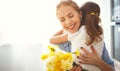 Happy mother`s day! child daughter gives mother a bouquet of f Royalty Free Stock Photo