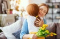 Happy mother`s day! child daughter gives mother a bouquet of flowers to tulip and gift Royalty Free Stock Photo