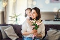 Daughter giving mother bouquet of flowers Royalty Free Stock Photo