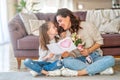 Daughter giving mother bouquet of flowers Royalty Free Stock Photo