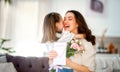 Daughter giving mother bouquet of flowers Royalty Free Stock Photo