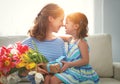 Happy mother`s day! child daughter gives mother a bouquet of f Royalty Free Stock Photo