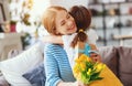 Happy mother`s day! child daughter gives mother a bouquet of flowers to tulip and gift Royalty Free Stock Photo