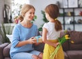 Happy mother`s day! child daughter gives mother a bouquet of flowers to tulip and gift Royalty Free Stock Photo