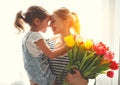 Happy mother`s day! child daughter gives mother a bouquet of f