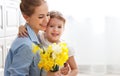 Happy mother`s day! child daughter gives mother a bouquet of f