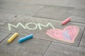 Happy Mother`s Day. Child draws for her mother a picture surprise of crayons on the asphalt. LOVE MOM Royalty Free Stock Photo