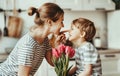 Happy mother`s day! child son gives flowers for mother on holiday