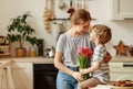 Happy mother`s day! child son gives flowers for mother on holiday