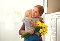 Happy mother`s day! child son gives flowersfor  mother on holiday Royalty Free Stock Photo