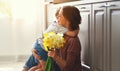 Happy mother`s day! child son gives flowersfor mother on holiday