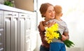 Happy mother`s day! child son gives flowersfor mother on holiday