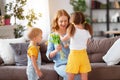 Happy mother`s day! Children congratulates moms and gives her a gift and flowers Royalty Free Stock Photo