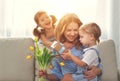 Happy mother`s day! Children congratulates moms and gives her a Royalty Free Stock Photo