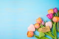 Happy Mother`s day concept with beautiful tulip flowers and heart shape on wooden background with copy space Royalty Free Stock Photo
