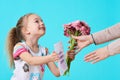 Happy Mother`s Day. Cute little girl giving mom greeting card and bouquet of pink gerbera daisies. Mother and daughter concept. Royalty Free Stock Photo