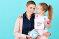 Happy Mother`s Day. Cute little girl giving mom mothers day card and a present. Mother and daughter concept.